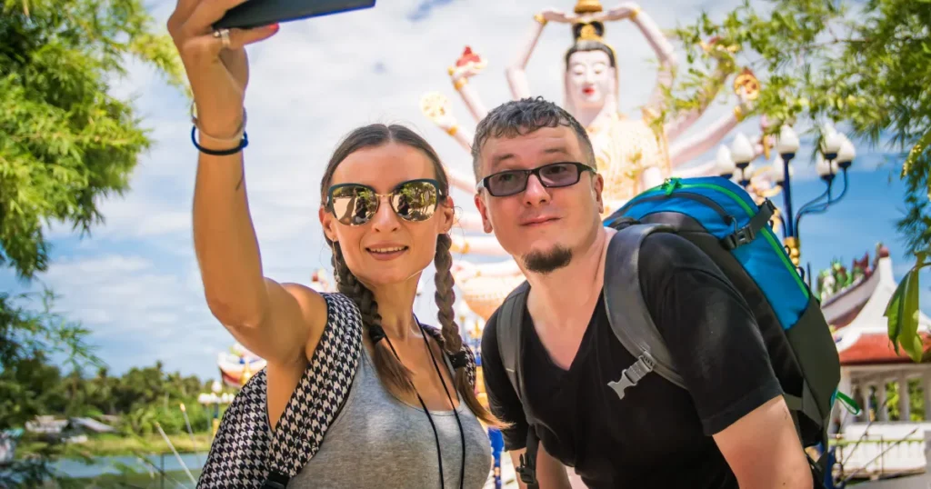 Couple taking a selfie at a Thai temple