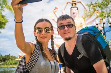 Couple taking a selfie at a Thai temple