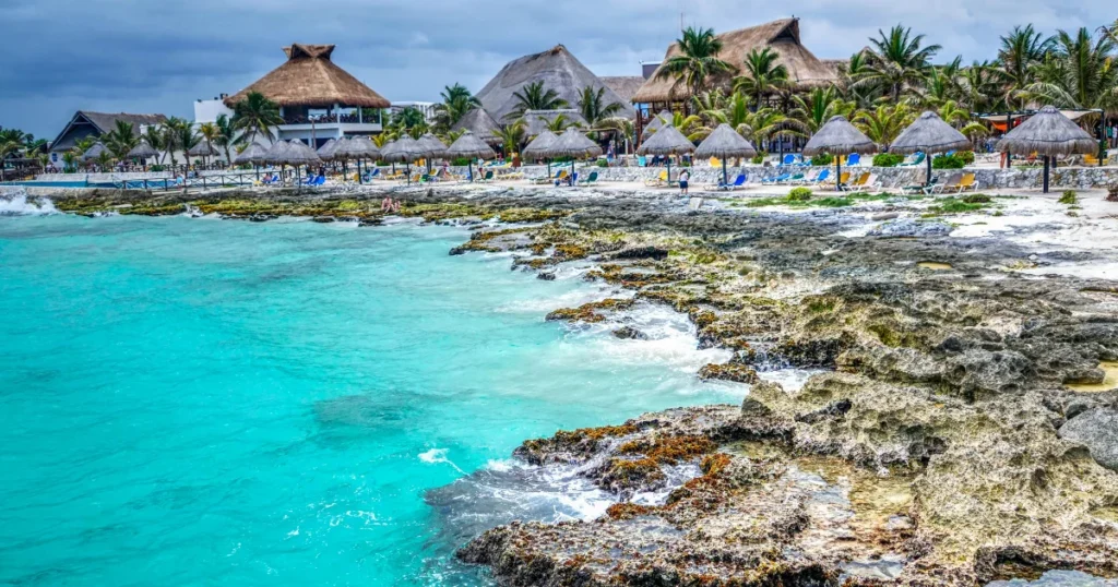 People walking near a white and brown building