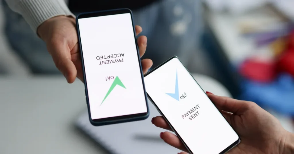 Two phones showing a confirmed money transfer