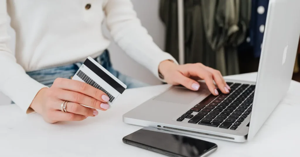 Woman using a credit card and laptop for online banking