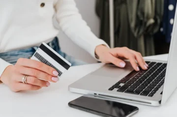 Woman using a credit card and laptop for online banking