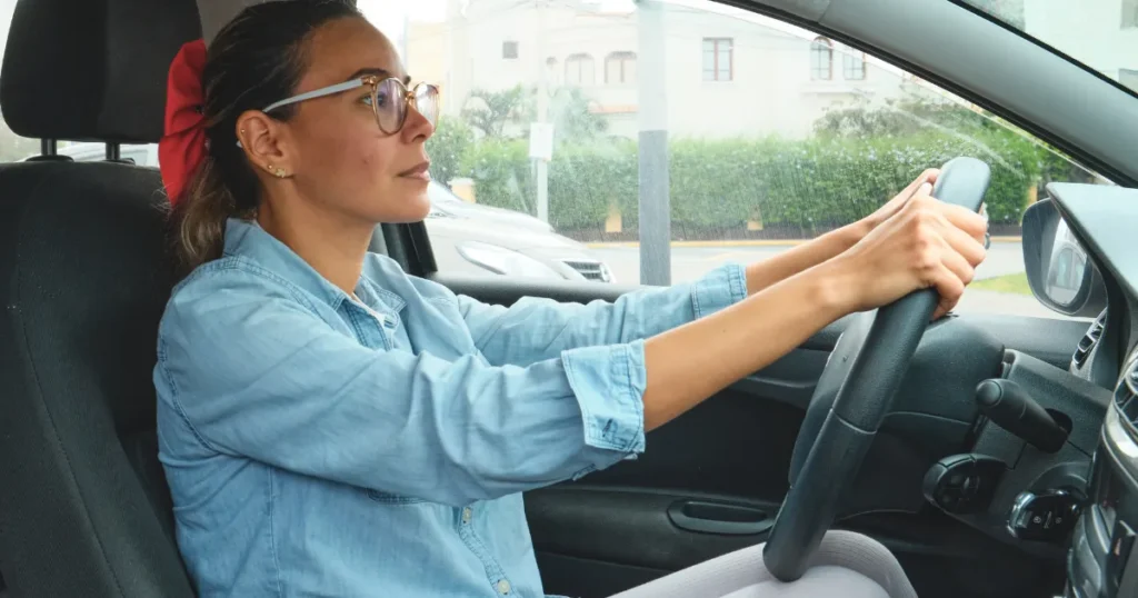 Woman wearing glasses while driving a car