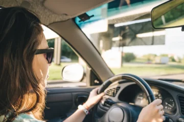 Rear view of a woman driving a car